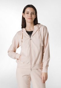 Sudadera ligera de color rosa claro con cremallera, hecha de una tela suave, con un bolsillo tipo canguro y capucha con cordón. Incluye puños y dobladillo acanalados.