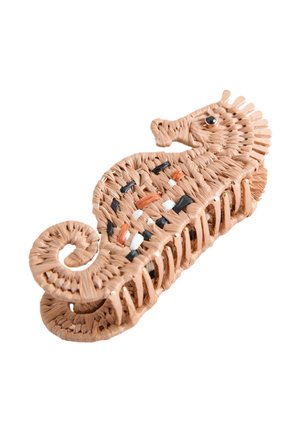 Seahorse-shaped hair clip made of woven brown material with black, white, and orange accents and a curled tail design.