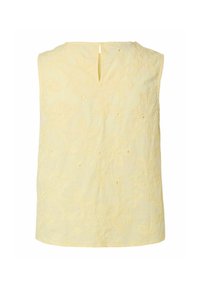 Blouse sans manches jaune pâle avec broderie florale et petite ouverture fendue à l'encolure dos.