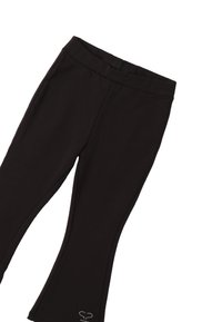 Leggings neri realizzati in tessuto elasticizzato con un design aderente, dotati di una cintura liscia e un piccolo accento decorativo vicino all'orlo.