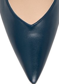 Navy blue leather pointed toe shoe with a v-shaped cutout on the upper. Smooth texture with a subtle sheen. Elegant and modern design.