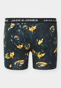 Schwarze Boxershorts mit floralem Muster in Gelb und grünen Blättern, ausgestattet mit einem schwarzen Bund mit dem weißen "JACK & JONES"-Logo.