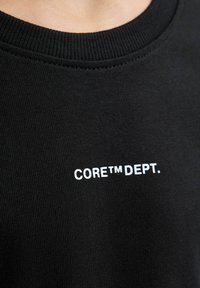 Černá mikina s žebrovaným výstřihem, vyrobená z texturované látky, s potiskem "CORE™ DEPT." v bílé barvě na přední straně.