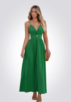 Robe maxi verte avec un décolleté en V profond, détail en torsion à l'avant et trou côté. Fabriquée en tissu léger, elle présente une taille élastique et une jupe fluide.