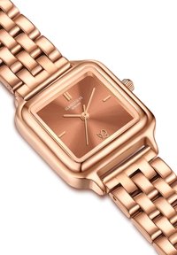 Roosa kuldne metallist käekell ruudukujulise näo, mustrilise kellaplaadi ja kuldsete aksessuaaridega. Omab kudumist vööd ja väikest kroonit külgedel.