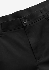 Black trousers featuring a smooth, textured fabric, a button closure, and a clean waistband design with subtle stitching details.