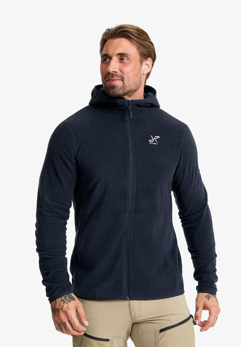 Marineblaue Fleece-Hoodie mit vollem Reißverschluss, weicher Textur und Logo-Detail auf der Brust. Mit Kapuze und enganliegenden Ärmel. Lässige Passform.