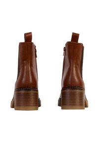 Bottines en cuir marron avec une finition lisse, des zips sur les côtés et un talon en bois empilé. Elles sont dotées d'une languette à l'arrière pour un enfilage facile.