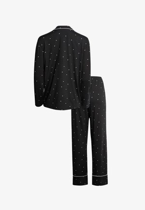 Černá dlouhý rukáv pyžamová souprava s bílým vzorem srdíček, bílým lemem na límci a manžetách kalhot, zobrazena zezadu.