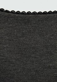 Black fabric featuring a textured surface and a distinctive scalloped lace trim along the top edge.