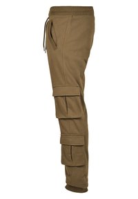Cargo joggere i khaki bomullsblanding, med sidelommer og flapper i cargo-stil. Ribbestrikket mansjettdetalj ved anklene gir struktur.