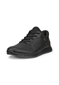 Zapatilla deportiva negra casual con diseño de cordones, suela acolchada y collarín acolchado en el tobillo, mostrada en un ligero ángulo sobre fondo blanco.