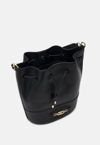 Black leather bucket bag with a drawstring closure, gold hardware, and a smooth texture. Features a logo detail on the front panel.