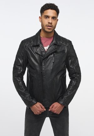 Black leather motorcycle jacket with a notched collar, zippered pockets, and quilted shoulder detail. Slim fit, smooth texture.