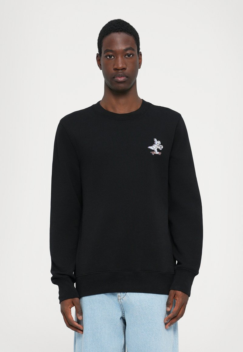 Black sweatshirt with a crew neck and long sleeves. Features a small colorful astronaut graphic on the chest. Soft, textured fabric.