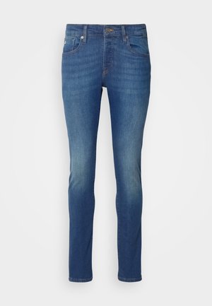 Blue denim jeans with a slim fit. Features a faded finish, five-pocket design, and metal hardware at the waist and pockets.