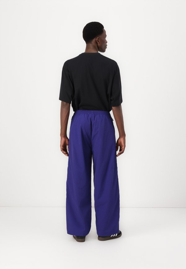 ADILENIUM SEASONAL 3 OVERSIZED SUPERSTAR TRACK - Tracksuit bottoms - night indigo3
