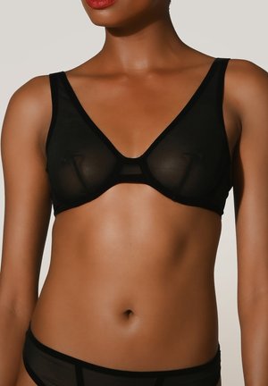 Schwarzer transparenter BH mit V-Ausschnitt, weichem Stoff und dreieckiger Form. Verfügt über transparente Netzpaneele und minimalistische Träger.