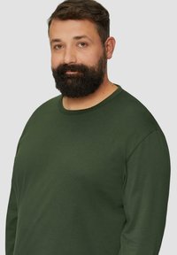 Langsleeve T-shirt in donkergroene katoen stof, met een ronde hals en een losse pasvorm, een gladde textuur en een minimalistisch ontwerp.