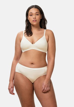 Beige seamless bra with adjustable straps and a v-neck design, paired with matching high-waisted briefs, both in smooth fabric.
