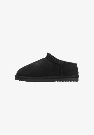 Black suede slip-on shoe with a rounded toe, soft texture, low profile, and a rugged rubber sole. Seam detailing along the side.