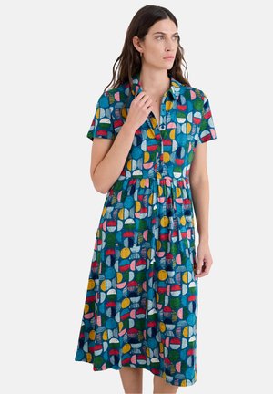 Short-sleeve, button-up dress featuring a blue background and a multicolored circular pattern with stripes and dots, flowing knee-length silhouette.