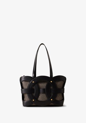 Large black tote bag featuring a unique circular design with gold accents. Constructed from textured fabric and leather, showcasing dual handles.