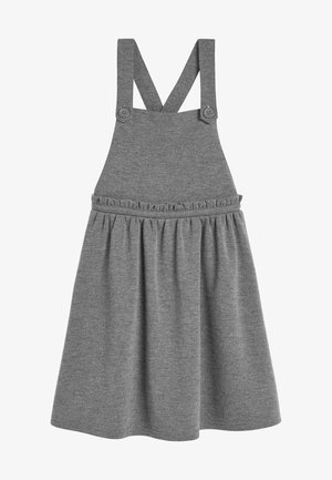 Robe salopette en tricot gris avec des bretelles croisées fixées par des boutons et une jupe froncée avec un subtil détail de volants à la taille.