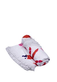 Cotton beach towel, rolled with red and pink floral patterns on a white background, featuring knotted fringe edges.