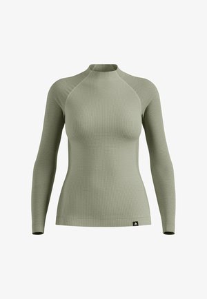 Long-sleeved performance top in light green, featuring a textured, ribbed fabric and a mock neckline with raglan sleeves.