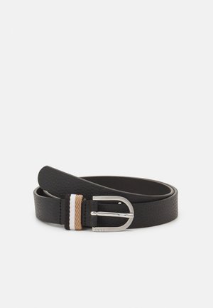 Black textured leather belt with silver oval buckle and stitched detail in beige, white, and black near the buckle.