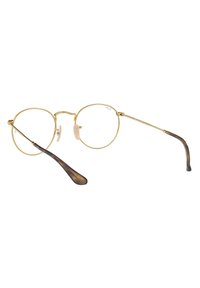 Occhiali rotondi in metallo dorato con lenti trasparenti, dotati di una montatura leggera e di un accento tartarugato sulle punte dei poggiatesta.