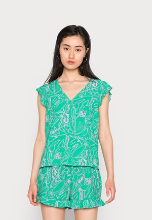 Top verde de manga curta com decote em V e padrão floral em branco e rosa, combinado com calções a condizer com bainhas onduladas.