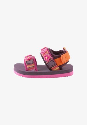 Child’s sandal with pink sole, purple footbed, orange heel strap, and pink floral-patterned adjustable fabric straps.