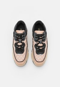 Quilted pink leather sneakers with black accents, round toe, black laces, and reflective detailing. Thick beige rubber sole.