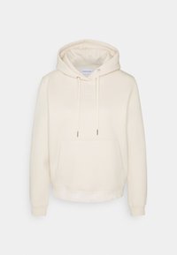 Sudadera color crema de tela suave, con un bolsillo frontal, cordones ajustables y una banda con logo a lo largo del dobladillo.