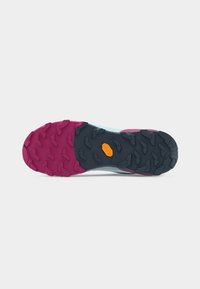 Hiking shoe sole with deep treads in pink and black rubber, featuring an orange Vibram logo in the center.