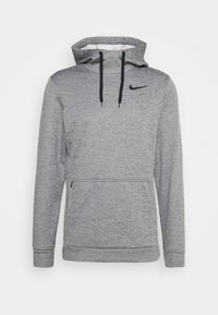 Harmaa huppari, jossa on kengurupocket, säädettävä huppu ja musta Nike-logo rinnassa. Valmistettu pehmeästä, tekstuuripinnoitteisesta kankaasta.