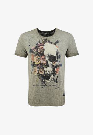 Camiseta gris con un gráfico de calavera rodeado de flores coloridas, con el texto "RESUCITA DE LAS CENIZAS" debajo del diseño.