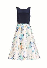 Robe fleurie avec un corsage marine et une jupe à fond crème clair, ornée de fleurs au style aquarelle en bleu, orange et vert.