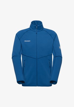 Giacca in pile blu con cerniera integrale, collo alto, due tasche con cerniera, logo "Mammut" sul petto e logo mammut sulla manica sinistra.