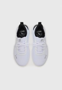 White athletic shoes with a textured mesh upper, black accents on the collar, and laces. Features a silver logo on the side and cushioned sole.