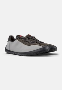 Lightweight shoes with a gray fabric upper and dark rubber sole. Features round laces and a rounded toe. Minimalist design with subtle accents.