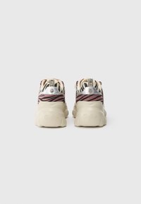 Buffalo sneakers featuring a zebra print design in shades of pink and cream, with a textured upper and a chunky beige sole.