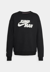 Felpa nera a manica lunga con la scritta bianca "JUMPMAN" e il logo Nike swoosh sul petto, piccolo logo Jumpman sul polsino sinistro.