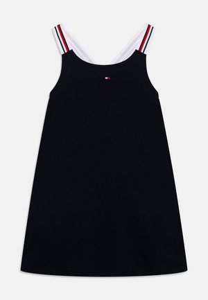 Black cotton dress with a sleeveless design, featuring white straps accented by red and blue stripes. Small logo on the front.