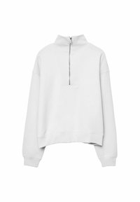 Sweat-shirt blanc à demi-fermeture éclair avec un col montant, une coupe décontractée et des poignets côtelés. Présente un design à découpe triangulaire à l'avant. Texture douce.