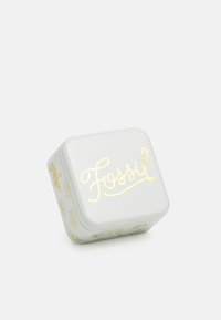 White square tin box with rounded edges, featuring gold foil "Fossil" logo and decorative patterns in light gray. Smooth metallic finish.