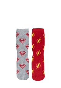 Grey sock with red Superman logos on one side; red sock featuring yellow Flash symbols on the other, both crafted from soft fabric.