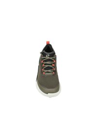 Green and gray athletic shoe with a textured upper, contrasting orange laces, white sole, and a red pull tab at the heel.